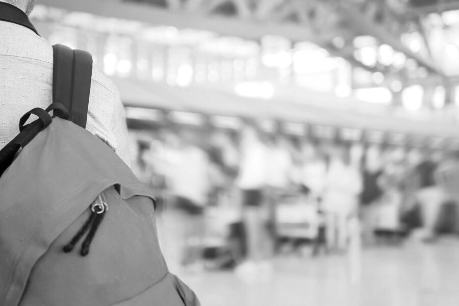 A traveller carries a bag in the airport.