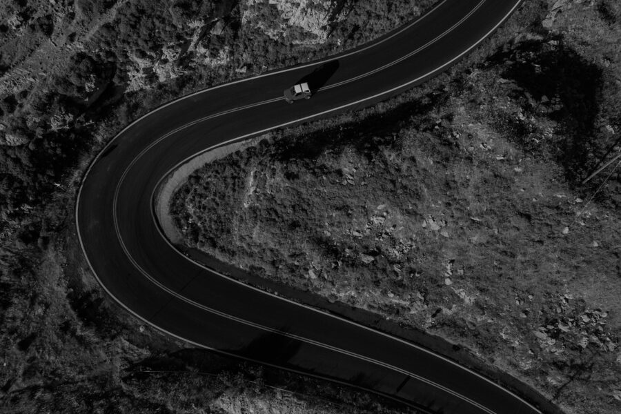 Image header for Customer Experience in 2025 of a car driving in the winding road